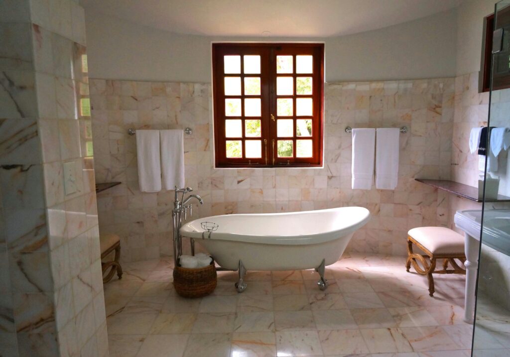 Luxurious bathroom featuring a classic freestanding bathtub and marble tiles.