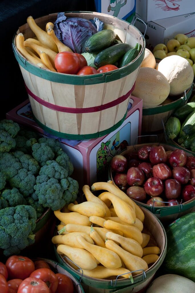 A vibrant display of fresh vegetables and fruits in baskets at a local market, showcasing healthy options.